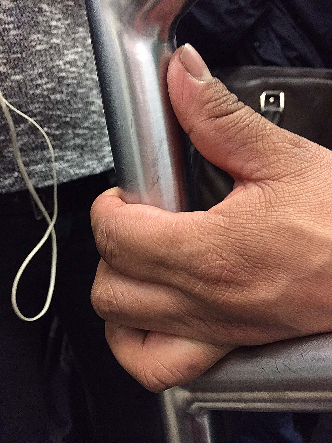hand-on-subway-pole
